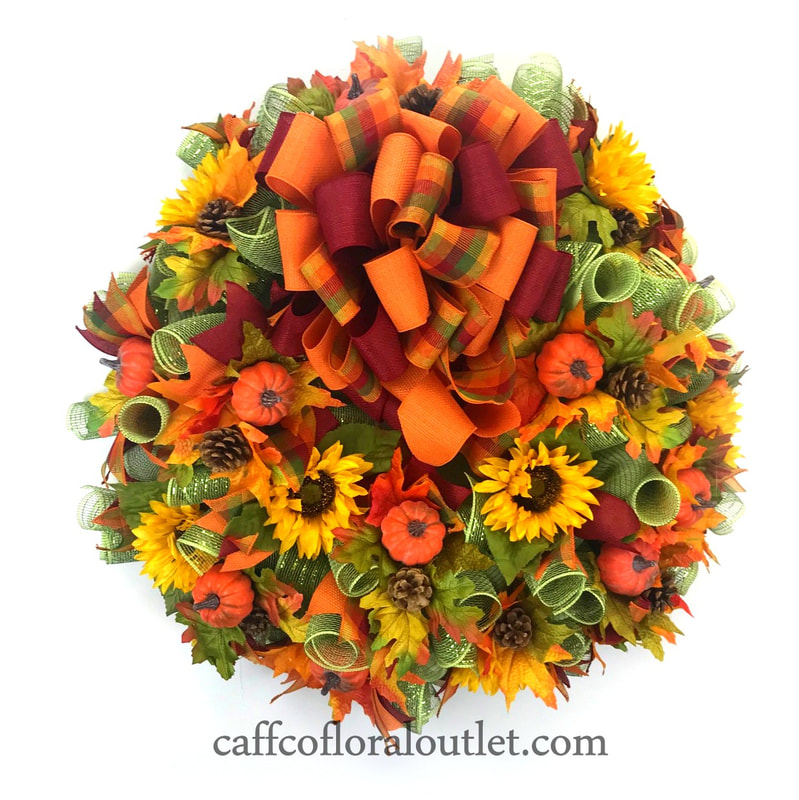 A lovely gold, green, yellow, orange and burgandy fall wreath  made with flowers, mesh, ribbons and faux pumpkins