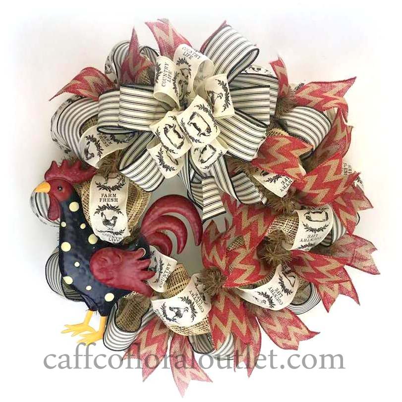 a wreath features multiple ribbons and a painted metal rooster