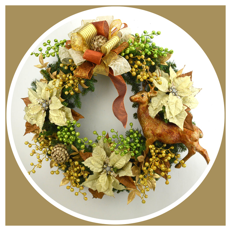 A Christmas wreath is adorned with jewel encrusted cream poinsettias, gold and green gittered berries, ornaments and a copped toned metallic deer