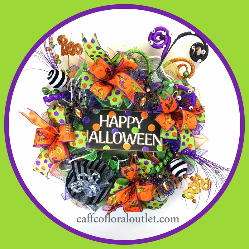 A happy halloween sign is the focal point of a wreath crafted with ribbon, plicks and mesh